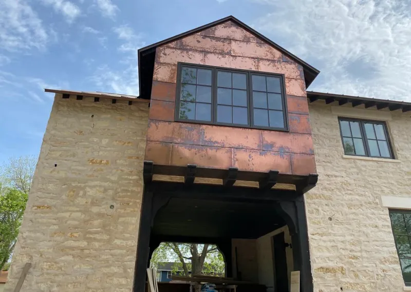 Copper metal panel facade on a stone building for Metal Roof Coating in Cheyenne