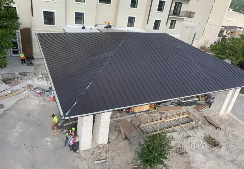 Metal roofing installation team working on a commercial building in Cheyenne
